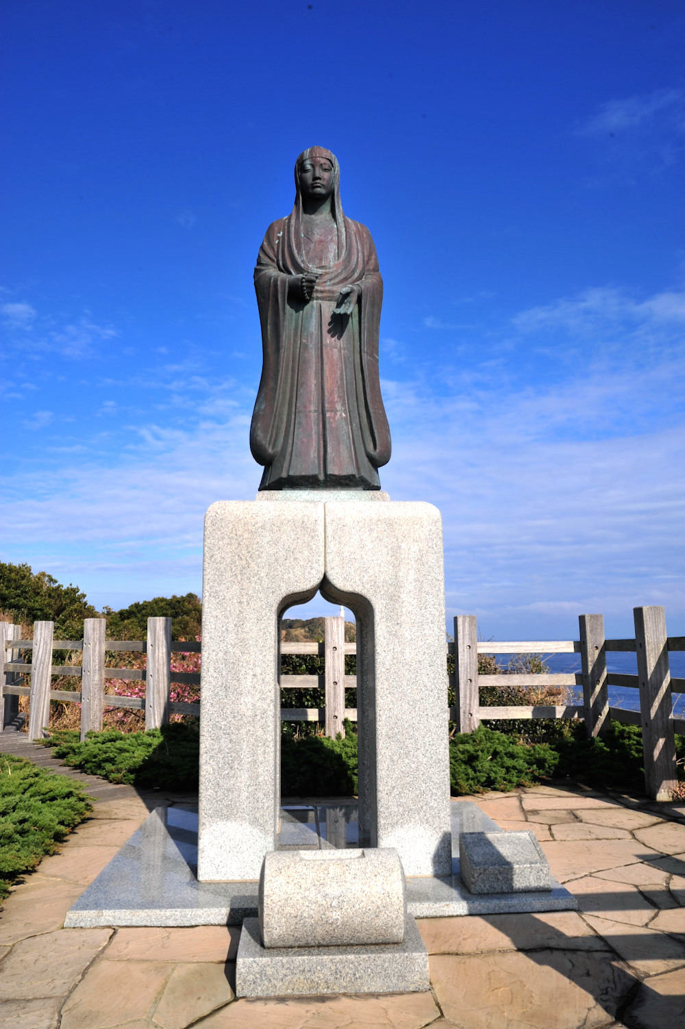 日の出と日没を拝む岬に配されたお万の像